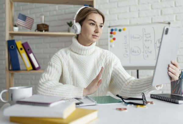 young-woman-teaching-kids-english-lesson-online